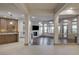 Bright living space with fireplace open to modern kitchen and dining area at 9921 Mirada Dr, Las Vegas, NV 89144