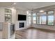 Bright living room with wood floors, modern fireplace, and expansive windows offering natural light at 9921 Mirada Dr, Las Vegas, NV 89144