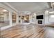 Open-concept living space with hardwood floors, fireplace, and open kitchen at 9921 Mirada Dr, Las Vegas, NV 89144