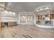 Open living space featuring hardwood floors, a bar area, and seamless access to kitchen and entryway at 9921 Mirada Dr, Las Vegas, NV 89144