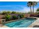Relaxing pool area with mature trees and a retaining wall for privacy at 9921 Mirada Dr, Las Vegas, NV 89144