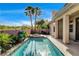 Refreshing swimming pool with a spa, surrounded by desert landscaping and elegant palm trees at 9921 Mirada Dr, Las Vegas, NV 89144