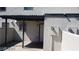 Small courtyard with gray concrete patio, stucco walls, covered patio, and sliding glass doors leading to house interior at 1336 N Jones Blvd, Las Vegas, NV 89108
