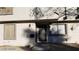 Two story residential building with neutral stucco exterior with dark trim, a front door, and small landscaped front yard at 1336 N Jones Blvd, Las Vegas, NV 89108