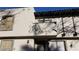 Two story residential building with neutral stucco exterior with dark trim, a balcony, front door, and small front yard at 1336 N Jones Blvd, Las Vegas, NV 89108