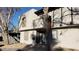 Two story residential building with neutral stucco exterior with dark trim, a balcony, front door, and small front yard at 1336 N Jones Blvd, Las Vegas, NV 89108