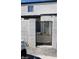 Gated residential entrance of complex with light gray stucco wall with black wrought iron gate to small courtyard at 1336 N Jones Blvd, Las Vegas, NV 89108