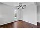 Simple bedroom with hardwood floors, ceiling fan, and window overlooking the community at 1405 Vegas Valley Dr # 98, Las Vegas, NV 89169
