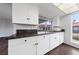 Bright kitchen featuring white cabinets, granite countertops, and modern appliances at 1405 Vegas Valley Dr # 98, Las Vegas, NV 89169