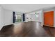 Bright living room with hardwood floors, leading to the kitchen and an orange front door at 1405 Vegas Valley Dr # 98, Las Vegas, NV 89169