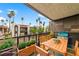 Private balcony perfect for outdoor dining and relaxation with views of tropical trees and neighboring buildings at 1405 Vegas Valley Dr # 98, Las Vegas, NV 89169