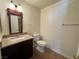 Bright bathroom featuring a granite vanity and dark wood cabinet, with tile flooring at 1505 Frank Aved St # 101, Las Vegas, NV 89110
