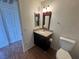 Cozy bathroom with a granite countertop vanity, decorative mirror, and tile flooring at 1505 Frank Aved St # 101, Las Vegas, NV 89110