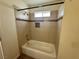 Bathroom featuring a tub with shower, mosaic tile, and tiled walls at 1505 Frank Aved St # 101, Las Vegas, NV 89110