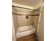 Clean, white bathtub with tiled walls and a sleek, black shower rod at 1505 Frank Aved St # 101, Las Vegas, NV 89110