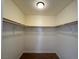 Walk-in closet with built-in shelving and wood floors at 1505 Frank Aved St # 101, Las Vegas, NV 89110