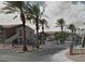 View of the community entrance with palm trees and well-maintained landscaping at 1505 Frank Aved St # 101, Las Vegas, NV 89110