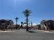 Gated entrance to the residential community with desert landscaping and palm trees at 1505 Frank Aved St # 101, Las Vegas, NV 89110