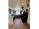 Kitchen featuring tile floors, black appliances, granite countertops, and dark wood cabinetry at 1505 Frank Aved St # 101, Las Vegas, NV 89110