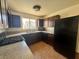 Kitchen featuring granite counters, dark wood cabinetry, and stainless steel appliances at 1505 Frank Aved St # 101, Las Vegas, NV 89110