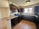 Kitchen featuring granite countertops, black appliances and dark cabinetry with tiled floors at 1505 Frank Aved St # 101, Las Vegas, NV 89110