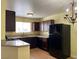 Cozy kitchen with dark cabinets, light countertops, and black appliances at 1505 Frank Aved St # 101, Las Vegas, NV 89110