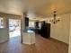 Open concept kitchen with dark cabinets, stainless appliances, granite countertops, and bar seating at 1505 Frank Aved St # 101, Las Vegas, NV 89110