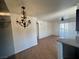 Living room featuring tile floors, ceiling fan, chandelier, and sliding glass doors to the balcony at 1505 Frank Aved St # 101, Las Vegas, NV 89110