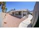 An enclosed backyard with patio, gravel, and palm trees offering a relaxed outdoor space at 1519 Deerford Cir, Las Vegas, NV 89110
