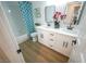 Bathroom showcases double sinks with wood-look tile flooring, ample lighting, and shower-tub combo at 1519 Deerford Cir, Las Vegas, NV 89110
