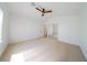 Bright bedroom features neutral carpet, ceiling fan and mirrored closet doors at 1519 Deerford Cir, Las Vegas, NV 89110