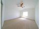 Vacant bedroom featuring vaulted ceilings, neutral carpet and natural light at 1519 Deerford Cir, Las Vegas, NV 89110