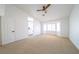 Airy bedroom featuring neutral carpet, a bay window and an adjoining bathroom at 1519 Deerford Cir, Las Vegas, NV 89110