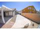 Wide concrete driveway leading to the house, bordered by a brick wall and desert landscaping at 1519 Deerford Cir, Las Vegas, NV 89110