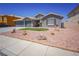 Charming single-story home featuring a well-manicured yard, neutral tones, and a two-car garage at 1519 Deerford Cir, Las Vegas, NV 89110