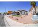 Well-manicured front yard featuring desert landscaping and a spacious driveway at 1519 Deerford Cir, Las Vegas, NV 89110