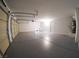 Spacious three car garage with epoxy flooring, water heater, and plenty of room for storage at 1519 Deerford Cir, Las Vegas, NV 89110
