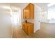 Hallway includes wooden cabinets and views of living area featuring tile flooring at 1519 Deerford Cir, Las Vegas, NV 89110