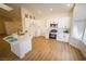 Bright, open kitchen featuring wood-look floors and modern white cabinets at 1519 Deerford Cir, Las Vegas, NV 89110