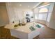 Bright kitchen featuring an island, stainless steel appliances and white cabinets at 1519 Deerford Cir, Las Vegas, NV 89110