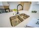 A stainless steel kitchen sink with a modern faucet and white countertop at 1519 Deerford Cir, Las Vegas, NV 89110