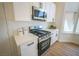 Well-lit kitchen featuring stainless steel appliances, white cabinets and light countertops at 1519 Deerford Cir, Las Vegas, NV 89110