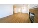 Open-concept living area featuring wood-look flooring, a modern fireplace, and access to other rooms at 1519 Deerford Cir, Las Vegas, NV 89110