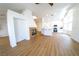 Bright living room featuring wood-look floors, a modern fireplace, kitchen access, and abundant light at 1519 Deerford Cir, Las Vegas, NV 89110