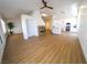 Open-concept living room showcasing wood-look floors, a modern fireplace, and a kitchen view at 1519 Deerford Cir, Las Vegas, NV 89110