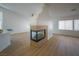 Living room featuring a modern corner fireplace and wood-look flooring at 1519 Deerford Cir, Las Vegas, NV 89110