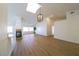 Bright and airy living room boasts vaulted ceilings, wood-look flooring, fireplace, and modern light fixture at 1519 Deerford Cir, Las Vegas, NV 89110
