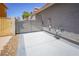 Concrete side yard enclosed with metal gate and adjacent to the house for secure parking or storage at 1519 Deerford Cir, Las Vegas, NV 89110