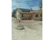 View of backyard area, featuring desert landscaping, a clothesline, and the exterior of the home at 1611 Red Rock Dr, Pahrump, NV 89048