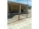 Backyard of property with a chain link fence and patio area with furniture at 1611 Red Rock Dr, Pahrump, NV 89048